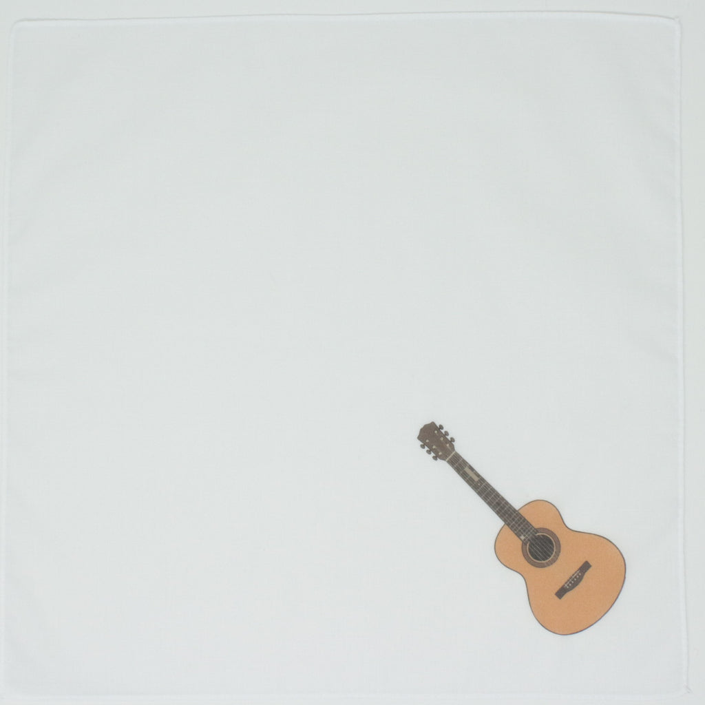 A square white fabric item, likely a handkerchief, featuring a small printed acoustic guitar illustration in the bottom-right corner.